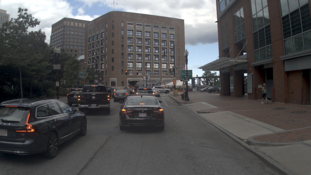 Current driving scene with a leading vehicle on an urban street.