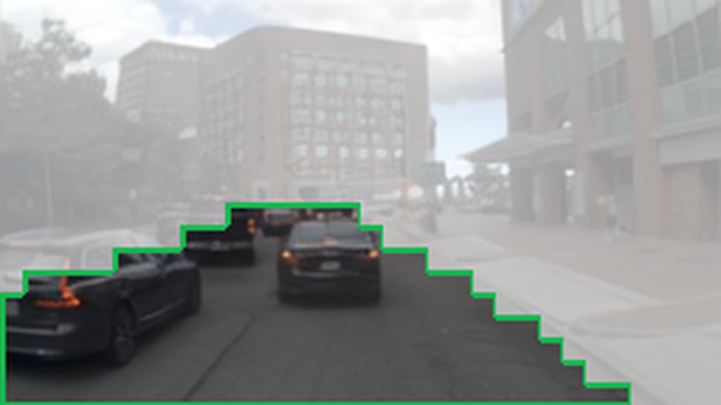 Predicted drivable area outlined in green.